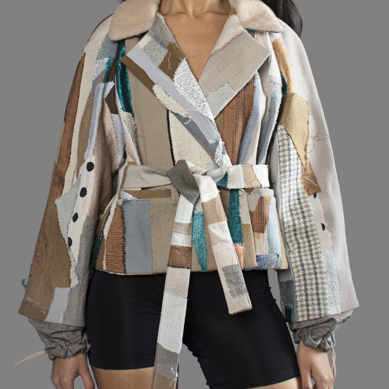 This is an image of a scrap suit jacket from the brand MiJA. It consists of mix of turquoise and beige fabrics.