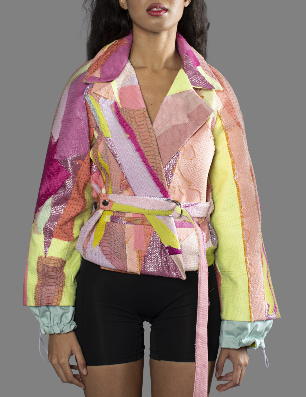 This is an image of a scrap suit jacket from the brand MiJA. It consists of mix of pink, yellow and green fabrics.