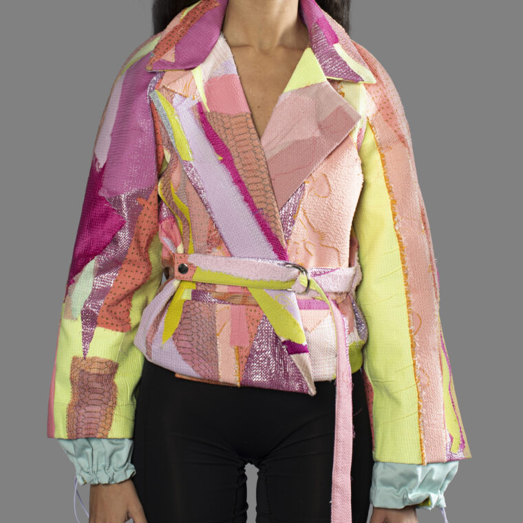 This is an image of a scrap suit jacket from the brand MiJA. It consists of mix of pink, yellow and green fabrics.