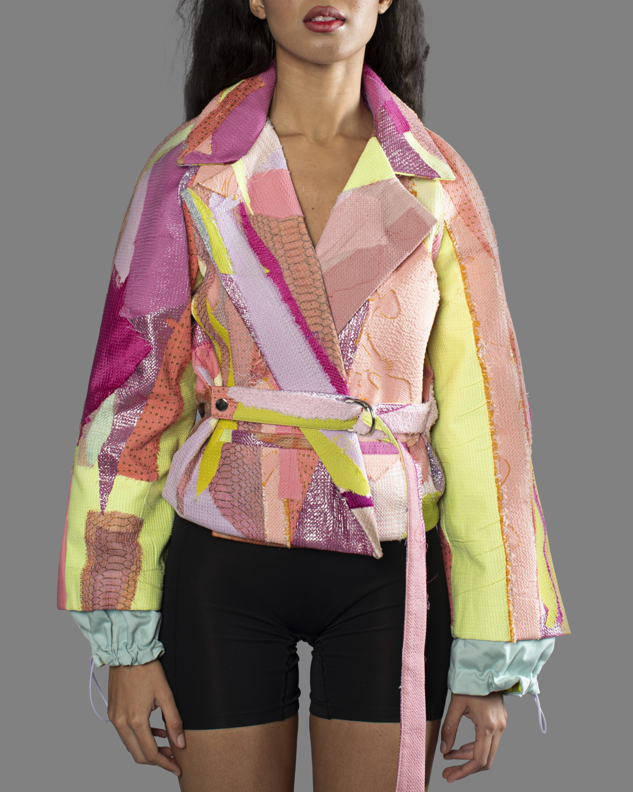 This is an image of a scrap suit jacket from the brand MiJA. It consists of mix of pink, yellow and green fabrics.