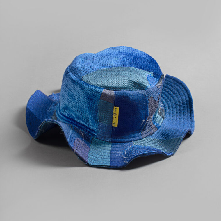 This is an image of a white scrap bucket hat which was made from fabric waste.