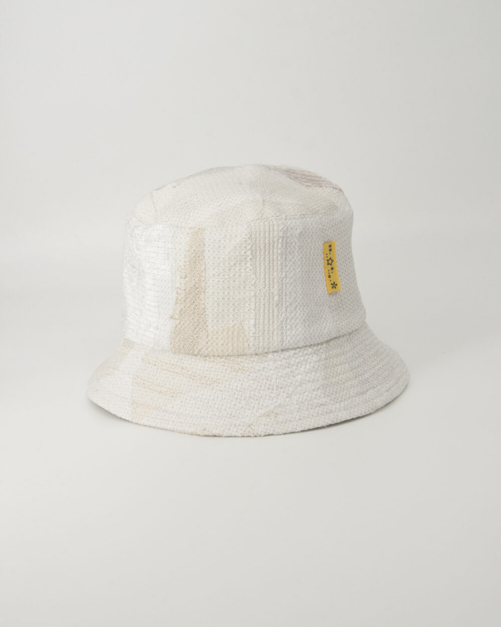 This is an image of a white scrap bucket hat which was made from white fabric waste.