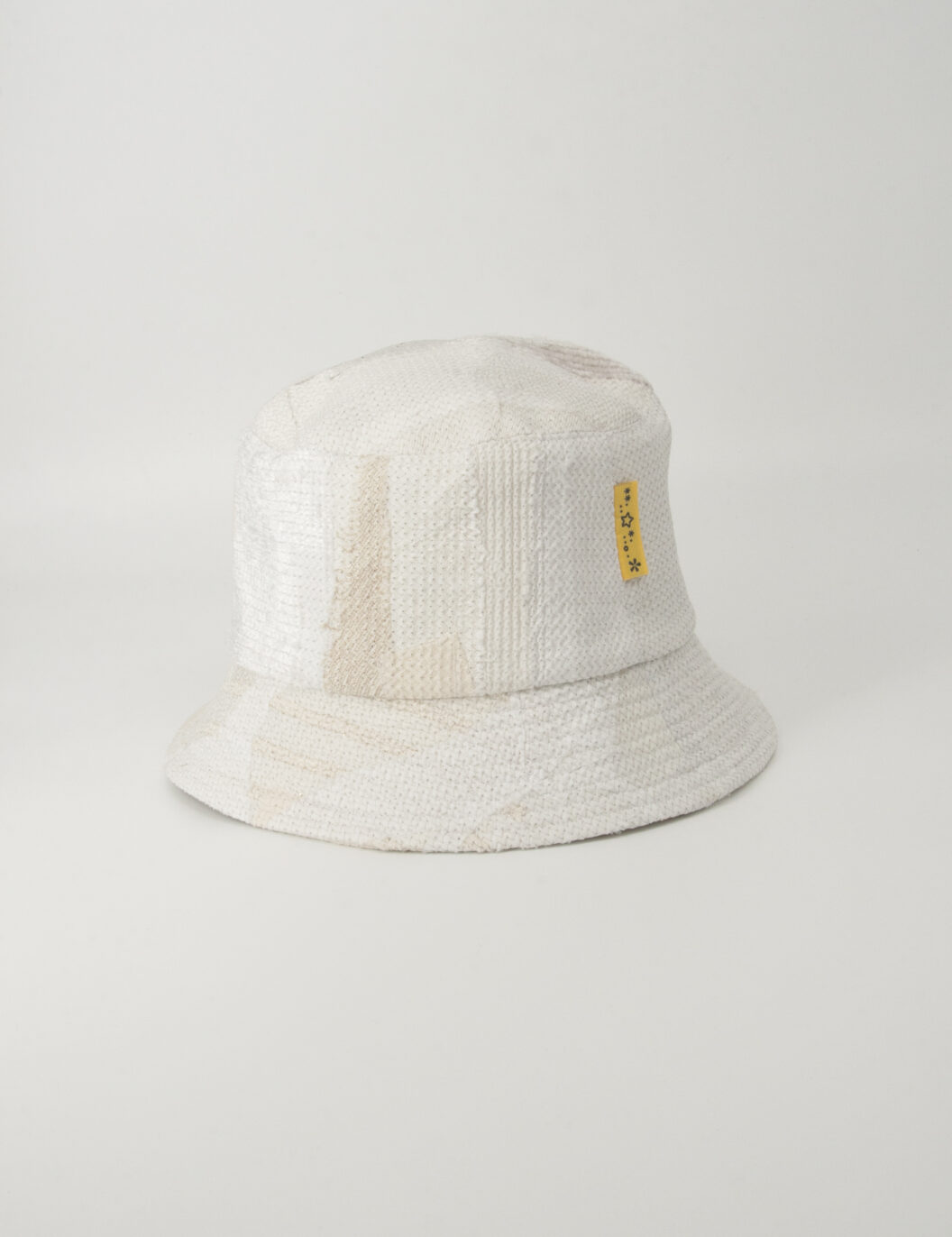 This is an image of a white scrap bucket hat which was made from white fabric waste.